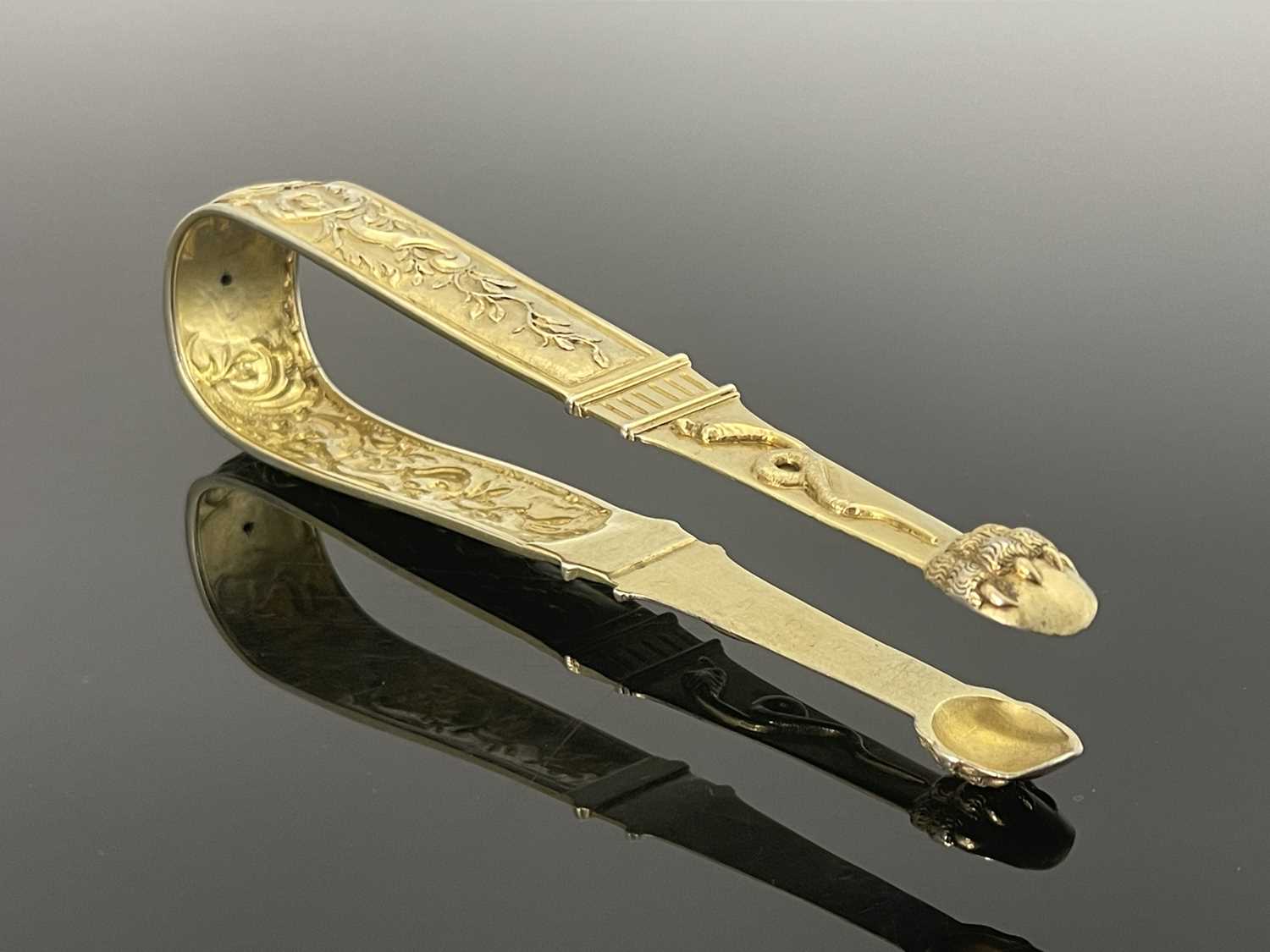 A large pair of Continental silver gilt sugar tongs, circa 1790, cast and chased in relief with - Image 2 of 3