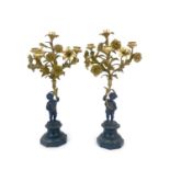 A pair of bronze and gilt metal figural candelabra, circa 1890, modelled as putti holding