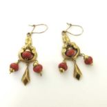 A pair of Victorian gold and coral earrings, open foliate scroll cartouches with three bead drops
