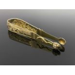 A large pair of Continental silver gilt sugar tongs, circa 1790, cast and chased in relief with
