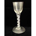 A double series opaque twist wine glass, circa 1755, the ogee bowl on a multi strand helix and