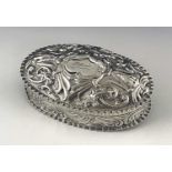 A Victorian silver embossed box, Horton and Allday, Birmingham 1890, oval form with domed hinged