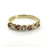 18ct gold half eternity ruby and diamond ring,the band set with four facet cut rubies and three