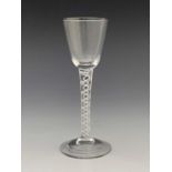 An opaque twist wine glass, circa 1760, the round funnel bowl on a double series, multi stranded