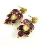 A pair of purple gem set multi drop earrings, gilt leaf motifs and facet cut stones (2)