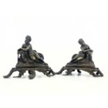 A pair of 19th century French bronze Rocco chenets of Rococo design, cast with a nude reclining