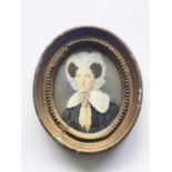 British School, circa 1840, oval portrait miniature of a lady, bust-length wearing a white lace