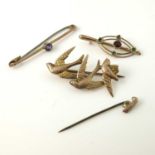 Three 9 carat gold brooches, including garnet and amethyst set examples and a three swallow example,