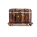 A Regency tortoiseshell tea caddy, circa 1820, of serpentine form with silver stringing inlay,