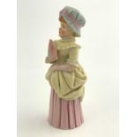 A Royal Worcester Town Girl candle snuffer, modelled as a Kate Greenaway character, pink and