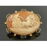 A shell cameo brooch, 9 carat gold mounted, depicting Diana in a horse drawn chariot, within a