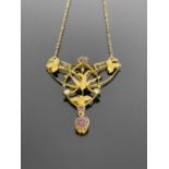 A 9ct gold garnet and seed pearl openwork pendant, the interlocking half moon and oval open