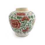 A Chinese polychrome ginger jar, probably Ming, painted with iron red peonies within a green foliate