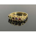 A late Victorian 9ct gold regard ring, collet set emerald, garnet, amethyst and diamond with one