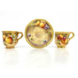 Frank Roberts for Royal Worcester, two fruit painted coffee cups, circa 1960, C scroll handles and