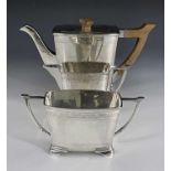 A George VI silver three piece tea set, Stower and Wragg, Sheffield 1939, Art Deco style bowed