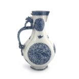 A Chinese blue and white ewer, lobed baluster form, relief moulded dragon handle, painted with