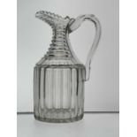 A cut glass claret jug, circa 1820, cylinder form with heavy fluting and stepped neck, helmet lip