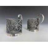 A pair of Continental or Eastern white metal filigree glass holders