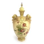 A Royal Worcester blush ivory vase and cover, ovoid form with relief moulded winged lion handles,