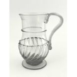 A George III glass tankard, circa 1770, footed baluster form, moulded wrythen fluting to the lower
