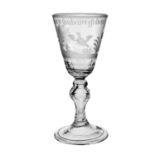 A Continental hollow baluster wine glass, circa 1750, the round funnel bowl engraved with