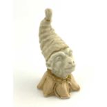 A Grainger Worcester novelty candle snuffer, modelled as a monkey in night cap, blush ivory and