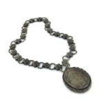 A Victorian silver locket on chased chain collar, alternating ring and foliate strap links