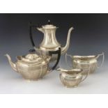 An Edwardian silver four piece tea and coffee set, Barker Brothers, London 1907, ogee section boat