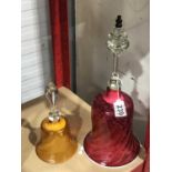 A Victorian Amber glass bell and a large Nailsea style cranberry glass bell, with knopped clear