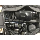 A bag of cameras and accessories, including an Olympus camera, lens etc