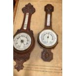 An late Victorian oak cased aneroid barometer, carved case, thermometer aperture above enamelled