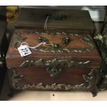 A Georgian mahogany tea caddy, scroll metal mounts, escutcheon, swing handle and feet, 25cm wide,