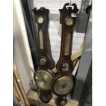 A mahogany and boxwood strung wheel barometer, with temperature gauge above mirrored aperture, and