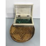 A vintage hardwood solitaire board, 26cm diameter, with a box of malachite polished beads