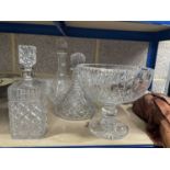 A silver collared but glass decanter, two other cut glass decanters and a cut glass bowl. (4)