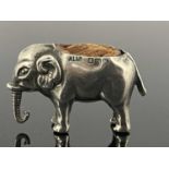 An Edwardian novelty silver pin cushion, modelled in the form of a standing elephant, Adie and