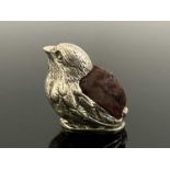 An Edwardian novelty silver pin cushion, modelled in the form of a chick, the body with cushion pad,