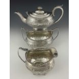 A George III Regency silver tea service, comprising teapot, sugar bowl and milk jug, each of ovoid