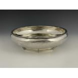 A George V Arts and Crafts silver bowl, of rounded circular form with slightly shaped rim, the