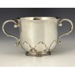 A George V silver two-handle porringer, modelled in the late seventeenth century style, with cut