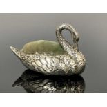 An Edwardian novelty silver pin cushion, modelled in the form of a swan, the body decorated to