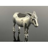 An Edwardian novelty silver pin cushion, modelled in the form of a standing donkey, Levi &