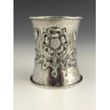 A George V silver Arts and Crafts napkin ring, of waisted cylindrical form, with spot-hammered