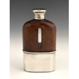 A Victorian hip flask, the glass body mounted with tooled leather, with silver screw thread cap with