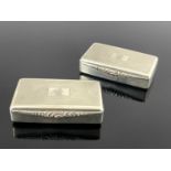 A pair of Elizabeth II silver snuff boxes, each of rectangular form with engine turned and reeded