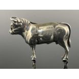 An Edwardian silver novelty pin cushion, modelled in the form of a standing bull, Cohen and Charles,