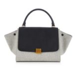 Celine, a Trapeze handbag, designed with a grey wool and smooth black leather exterior, featuring