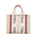 Chloe, a small Woody tote, designed with a beige canvas exterior and brown leather trim, featuring