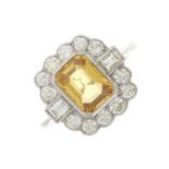 A platinum yellow sapphire and diamond cluster dress ring
